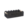 Woven paper storage basket in khaki colour on a desktop, holding remote controls and stationery.