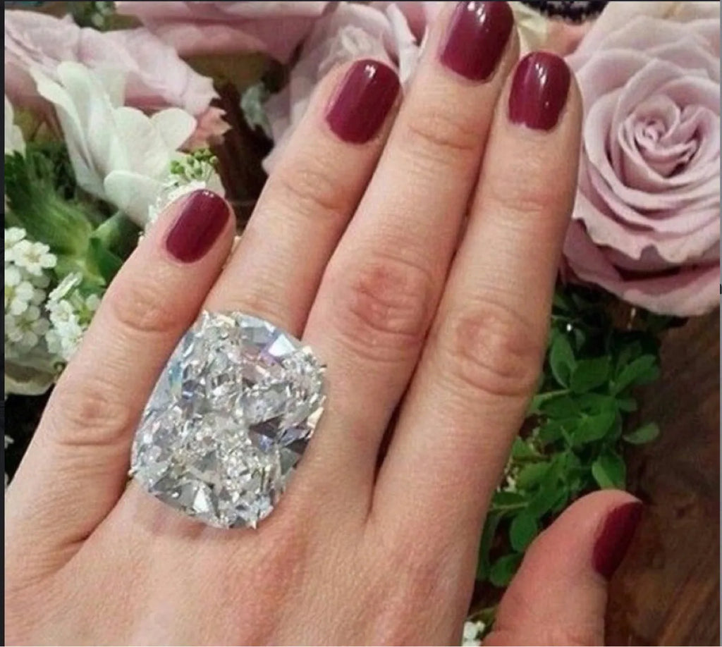 Simple white gold colour alloy ring with a geometric design and an inlaid square diamond.