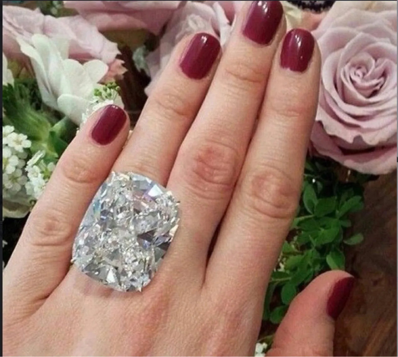 Simple white gold colour alloy ring with a geometric design and an inlaid square diamond.