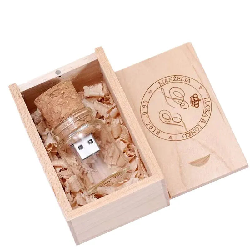Wooden-capped transparent glass bottle USB flash drive on a wooden surface.