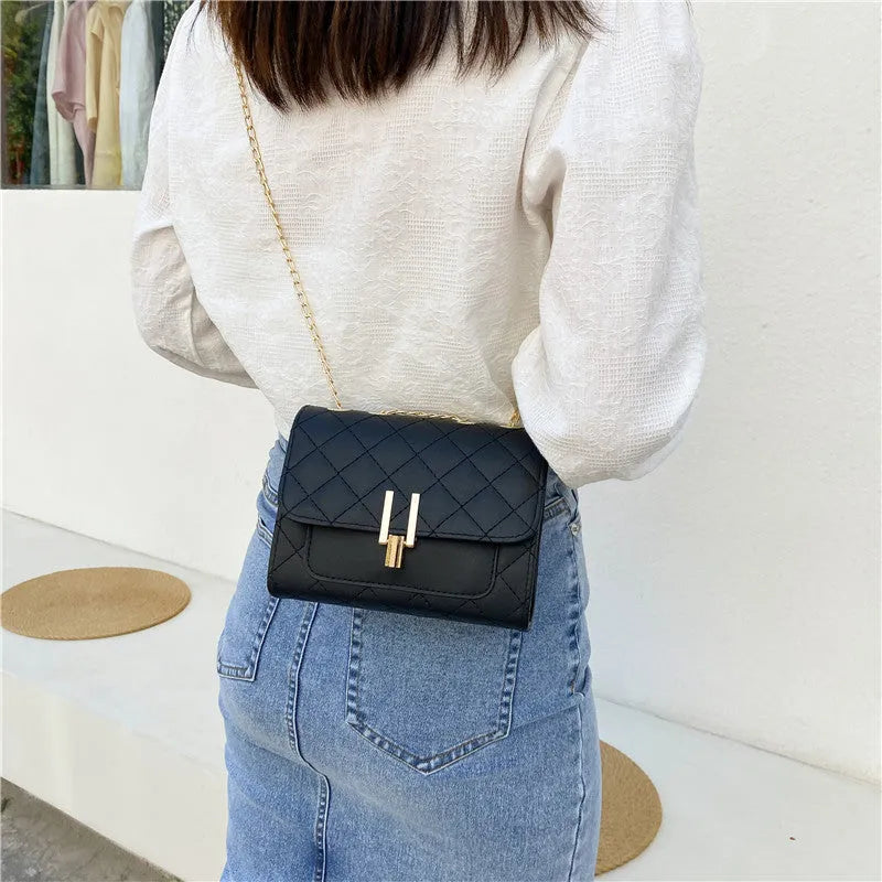 Women's black PU crossbody bag with a diamond lattice chain design on the front