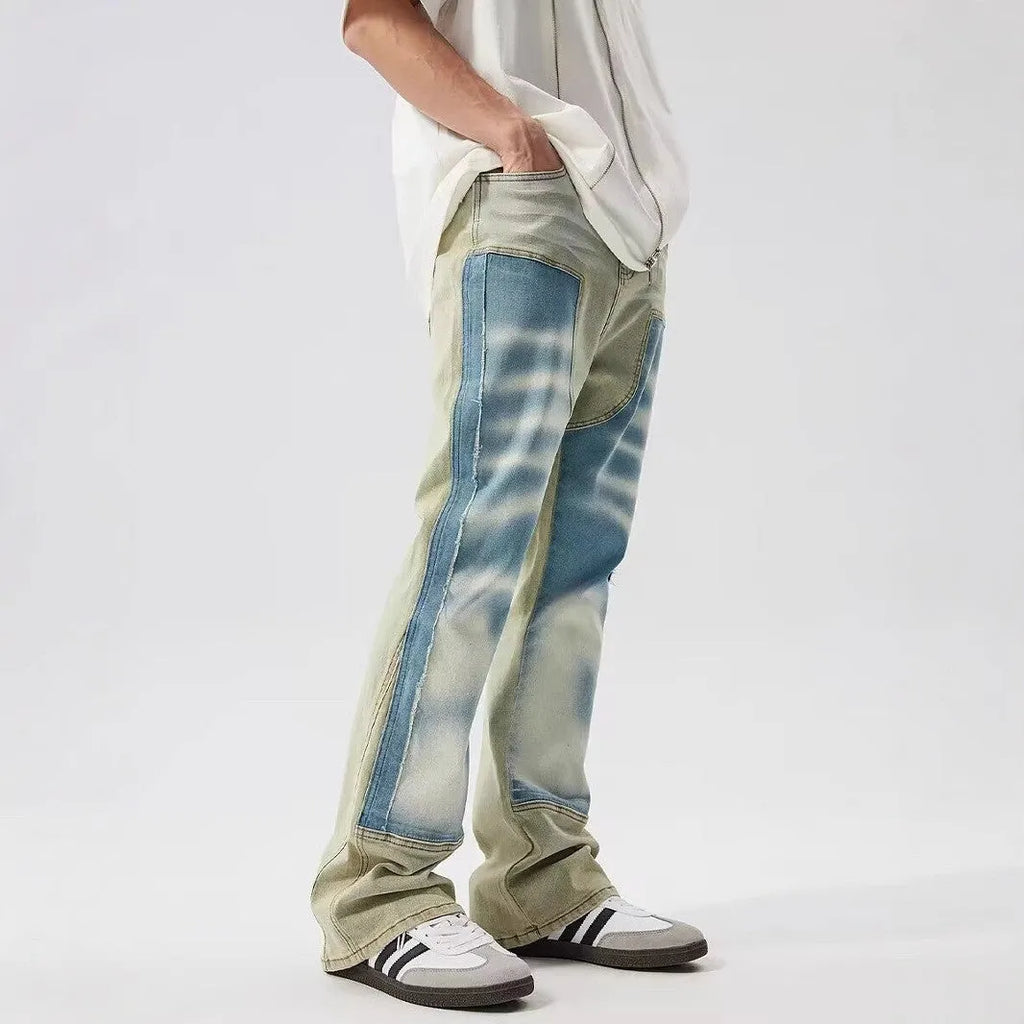 Yellow and blue retro patchwork distressed jeans on a model