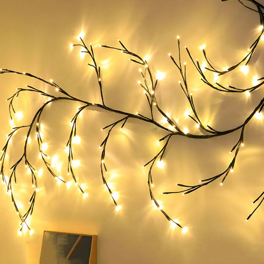 Flexible birch bark textured LED willow vine garland bent into shape with warm white lights.