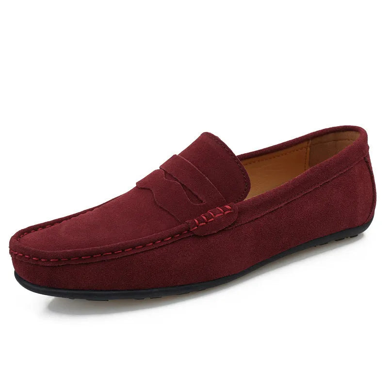 Men's solid colour suede leather slip-on loafers with a flat rubber sole.