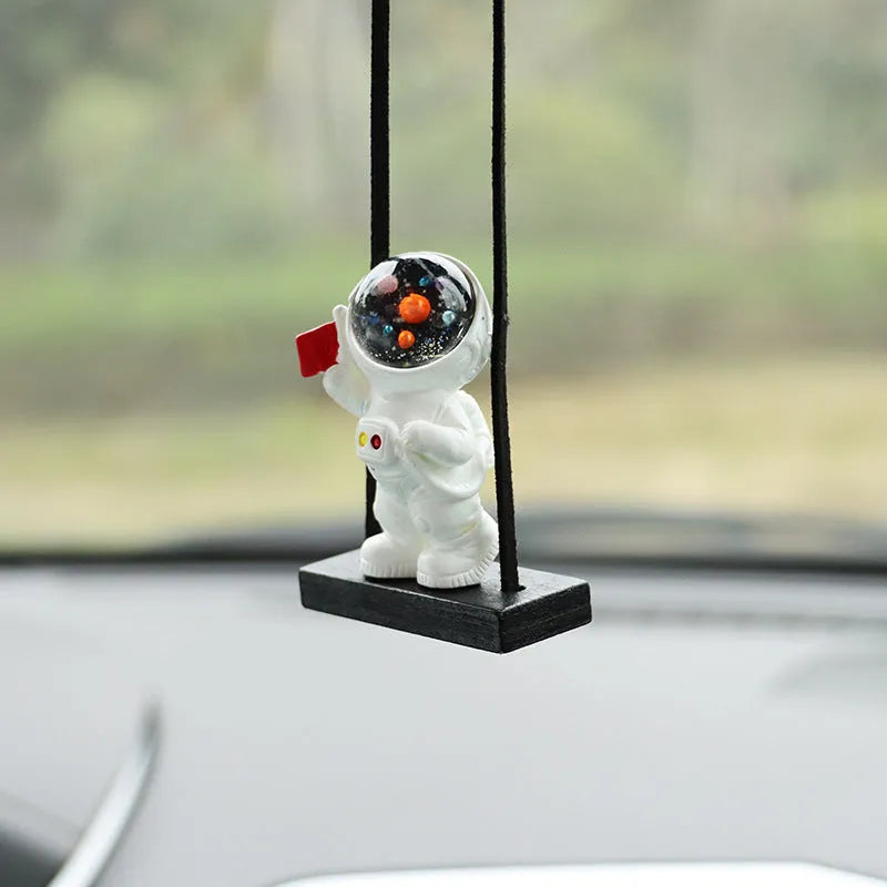 Resin cartoon astronaut car pendant showing designs like astronaut with telescope and astronaut holding a radish.