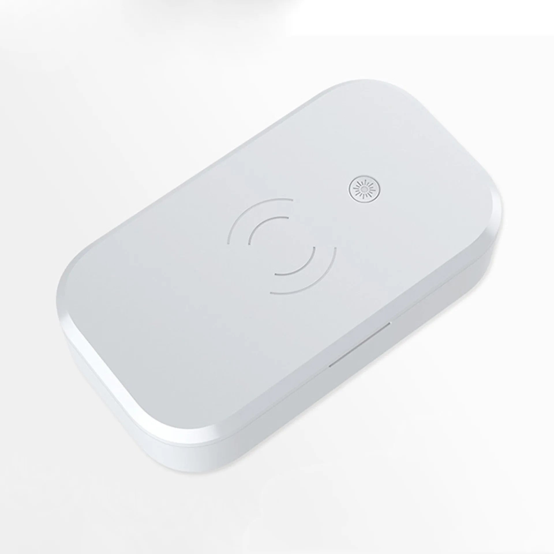 White ultraviolet disinfection box with wireless charging pad inside for phones and beauty tools.