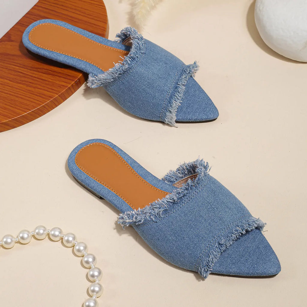 Women's denim flat slippers with tassel detail and leather lining in multiple colours.