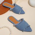 Women's denim flat slippers with tassel detail and leather lining in multiple colours.