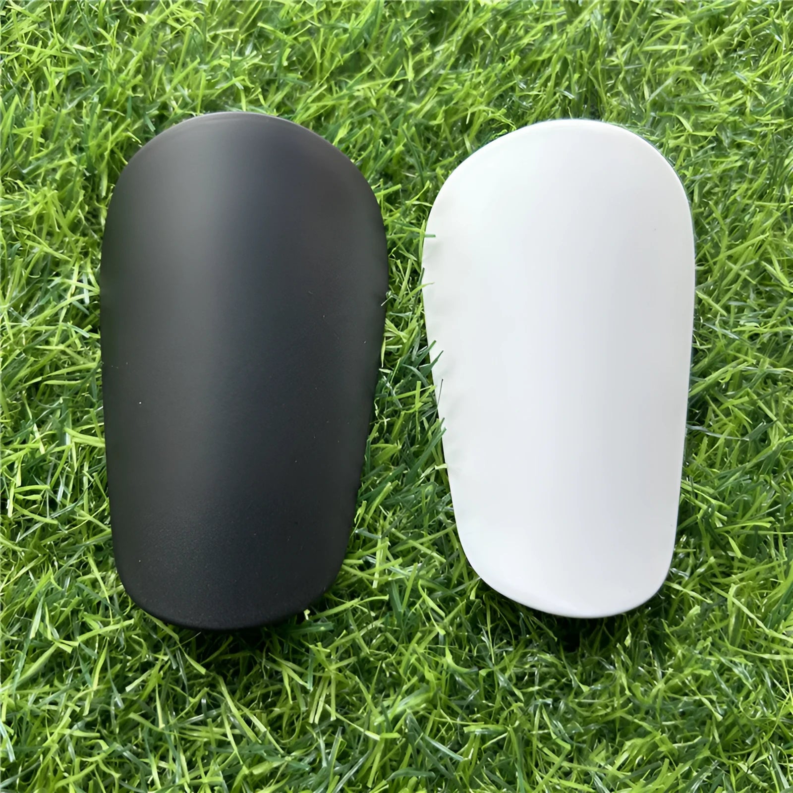 Extra small mini football shin guards plastic protection 8x5 cm black white youth