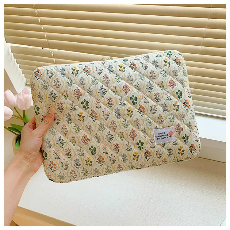 Flower print cloth laptop bag in green floral pattern showing three size options for laptop protection