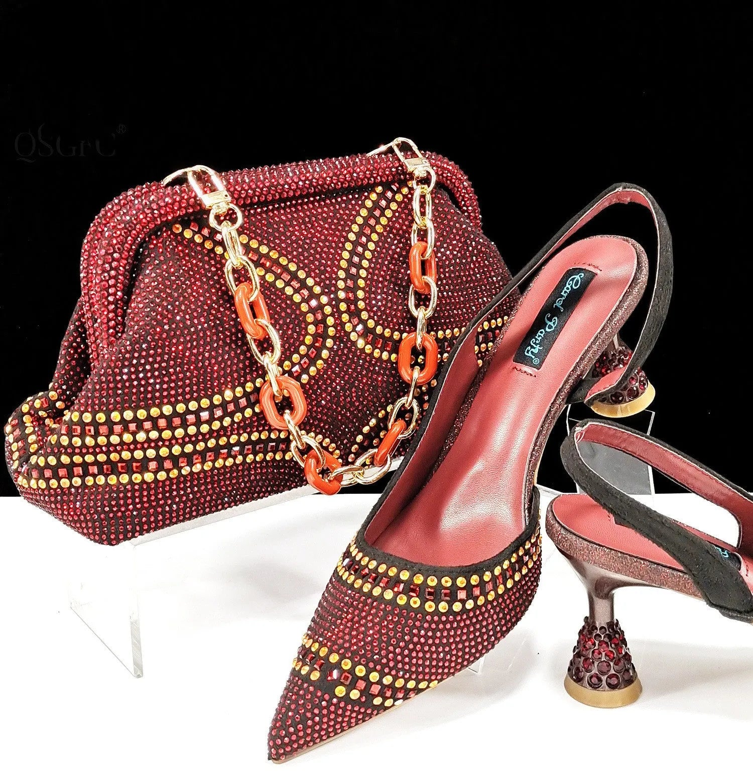 Women's pointed toe high heel shoes with decorative rhinestones and a matching small bag, shown in blue.