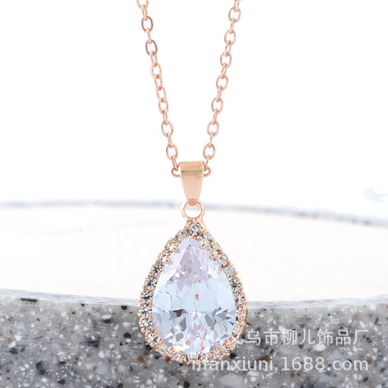 Pink water drop shaped rhinestone necklace with rose gold electroplated alloy pendant on white background