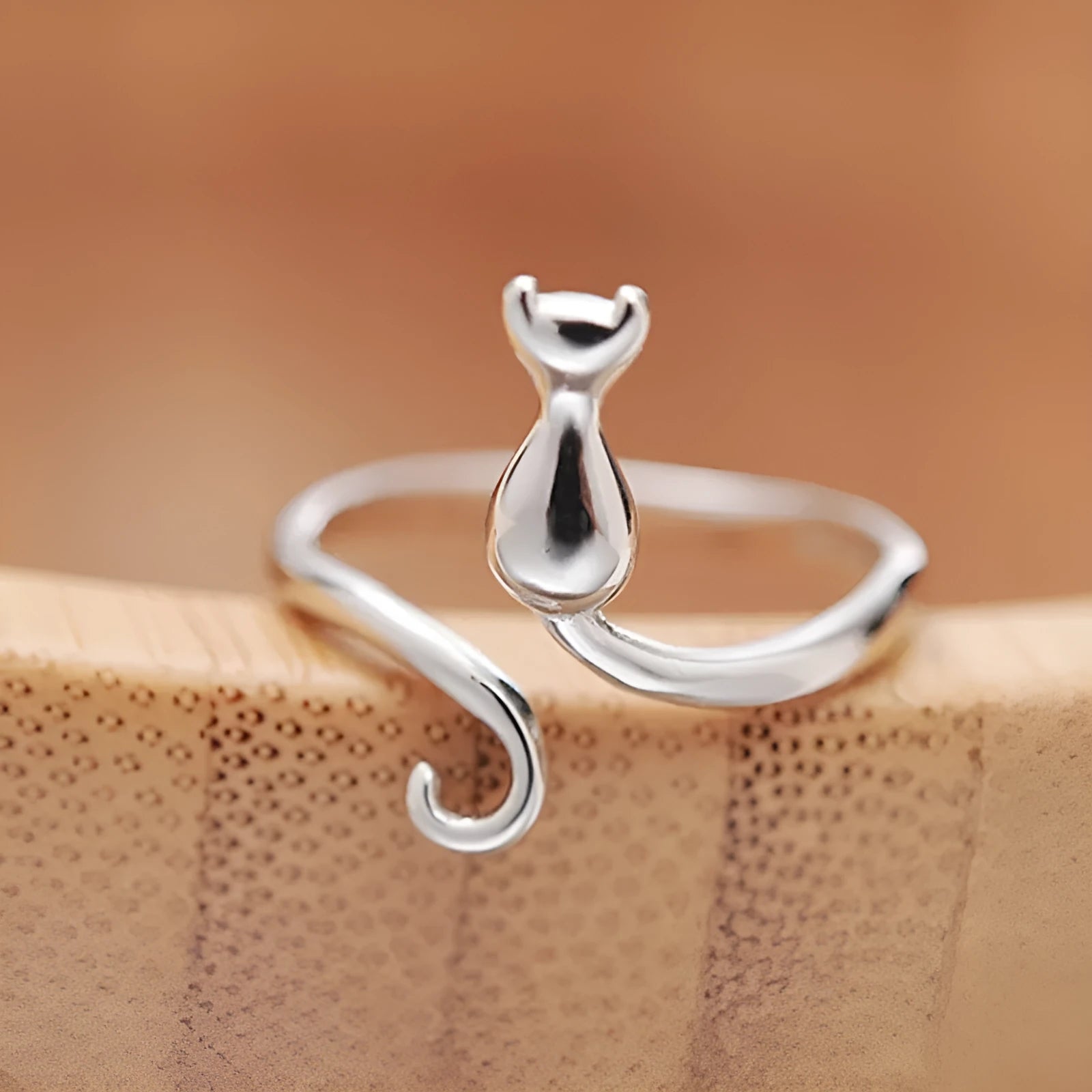 Platinum colour alloy cat face open ring with adjustable opening on white background
