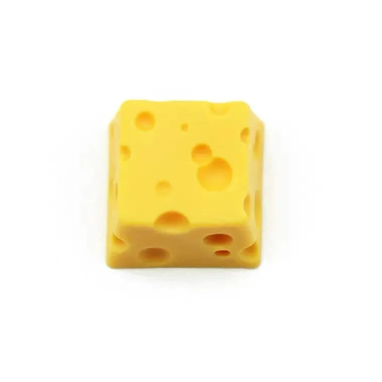 Yellow resin cheese artisan keycap for mechanical keyboards on a white background.