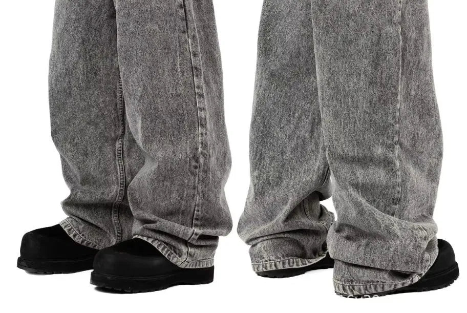 Grey loose straight-leg denim trousers with mid-waist styling on hanger