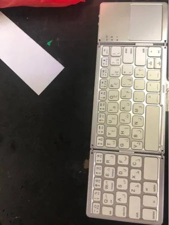 Tri-fold folding Bluetooth keyboard shown in both unfolded typing position and folded portable configuration