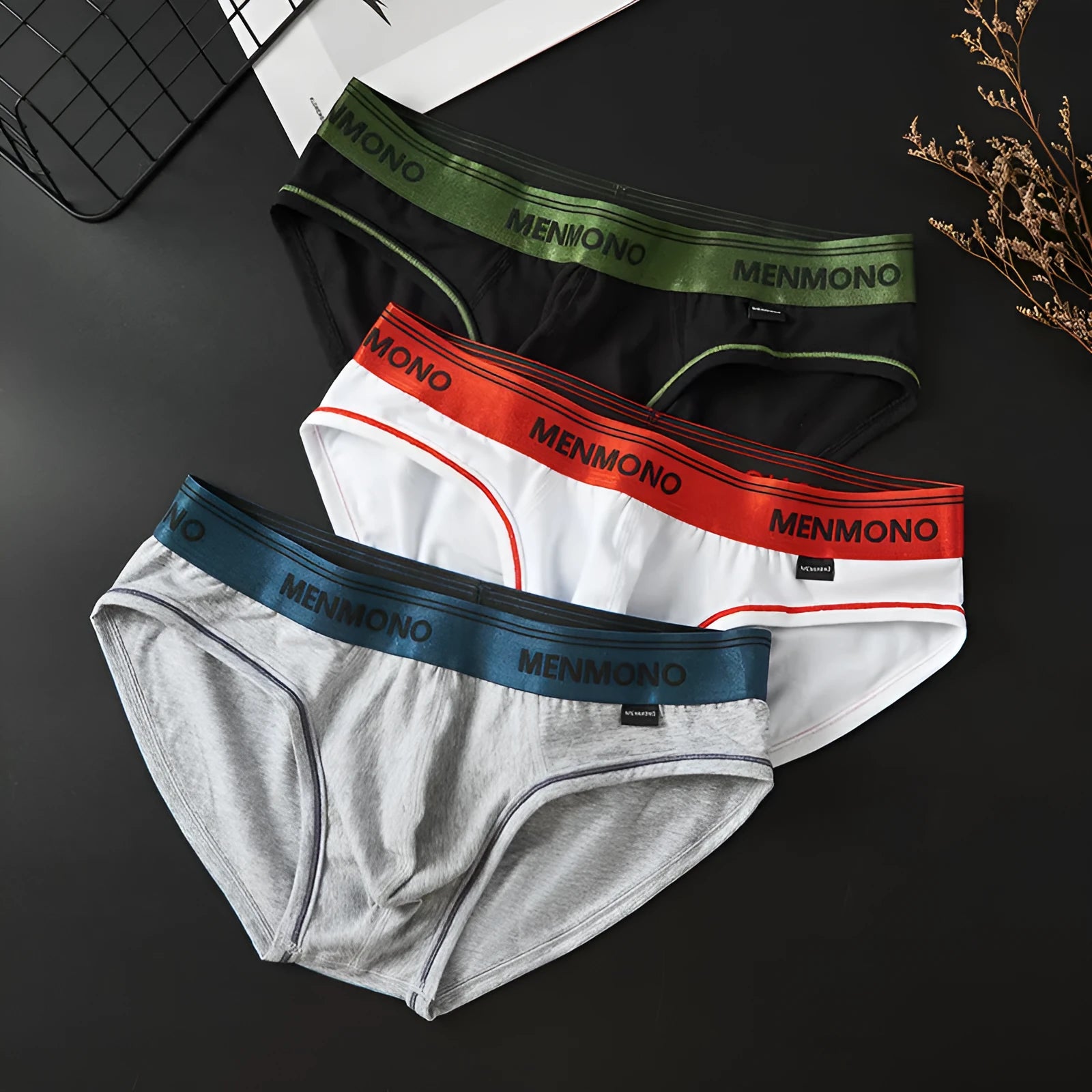 Men's low-waist cotton briefs shown in a two-tone colour combination, such as black with red trim.