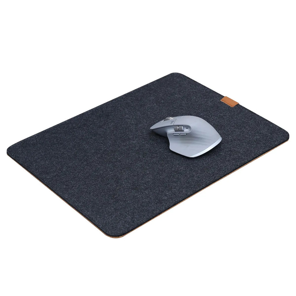 Oversized grey felt and cork desk mouse mat shown on a wooden desk with keyboard and mouse.