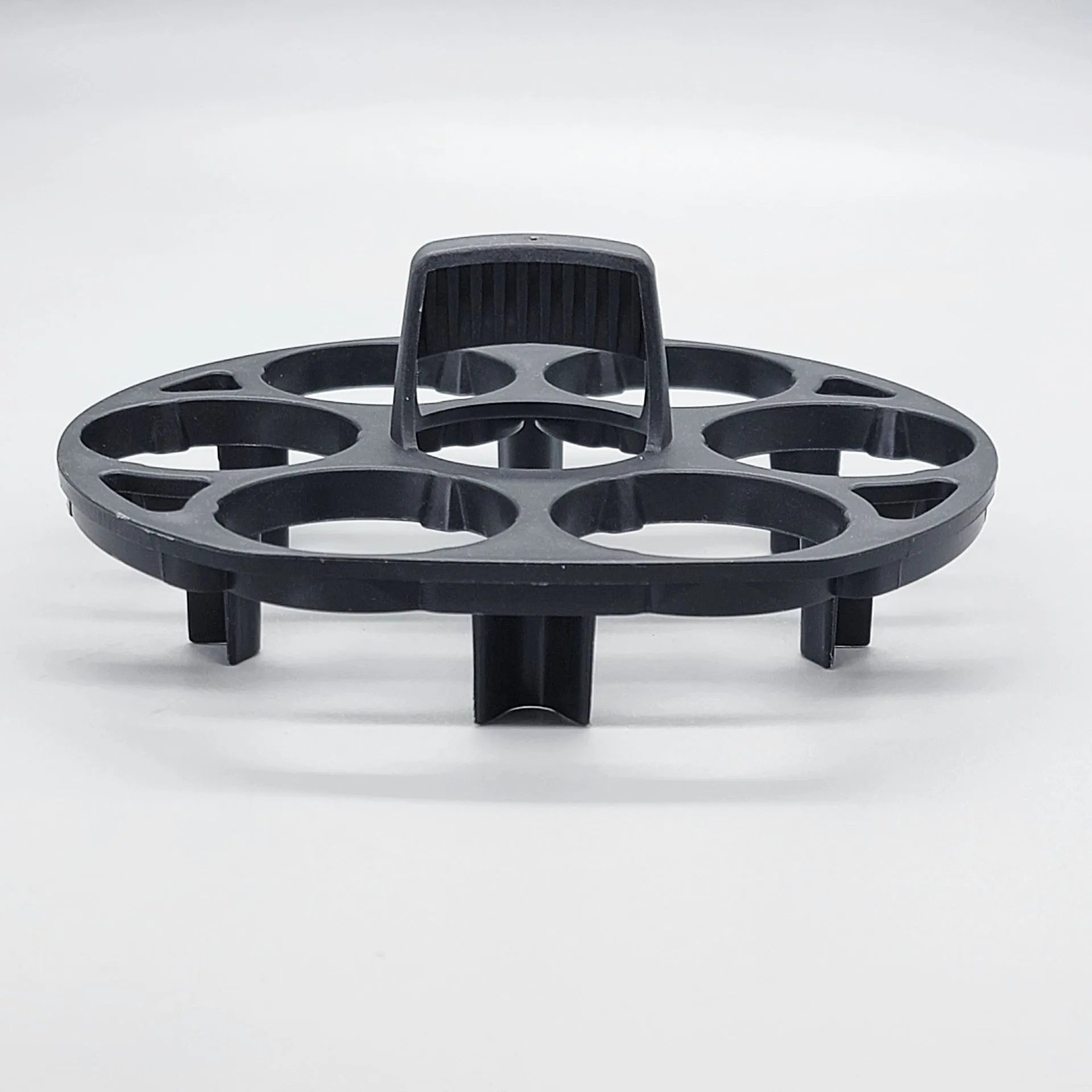 Black plastic egg holder rack with retainer for kitchen storage.