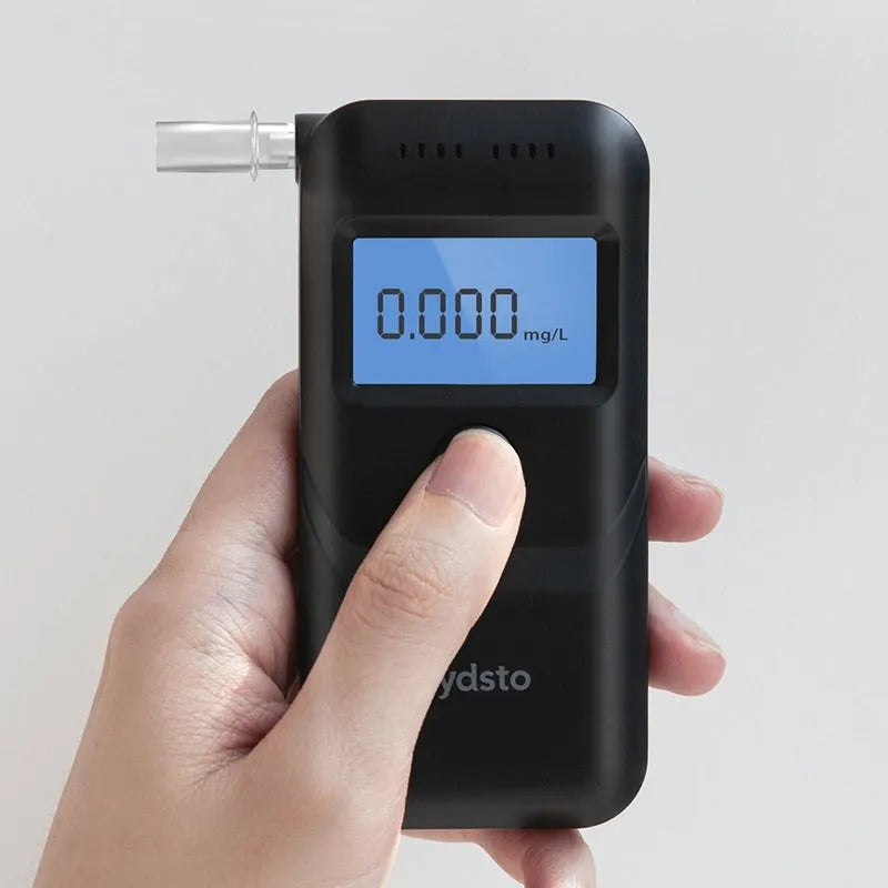Black household alcohol tester with digital display for breath checking and drunk driving prevention