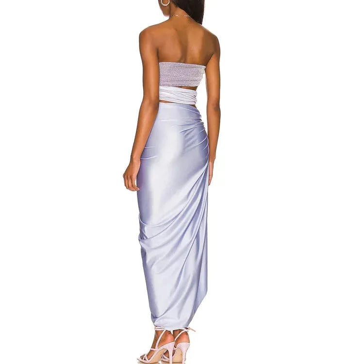 Purple one-piece swimsuit with coordinating wrap skirt set on beach background