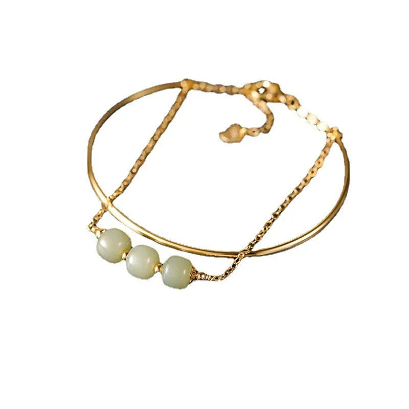 Women's jade bracelet with gold inlay detailing showing single, double and three bead versions