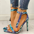 Blue women's high heel shoes with a buckle fastening and glossy patent leather finish.