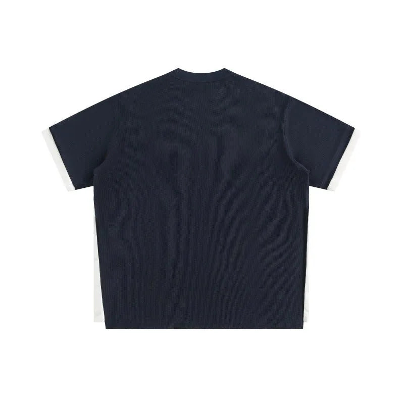 Loose fit short-sleeved waffle fabric t-shirt with retro alphabet embroidery, shown in yellow.