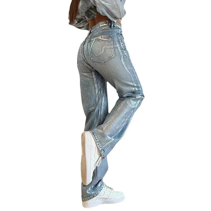Washed blue high waist straight leg jeans on a model, showing contrast colour details.