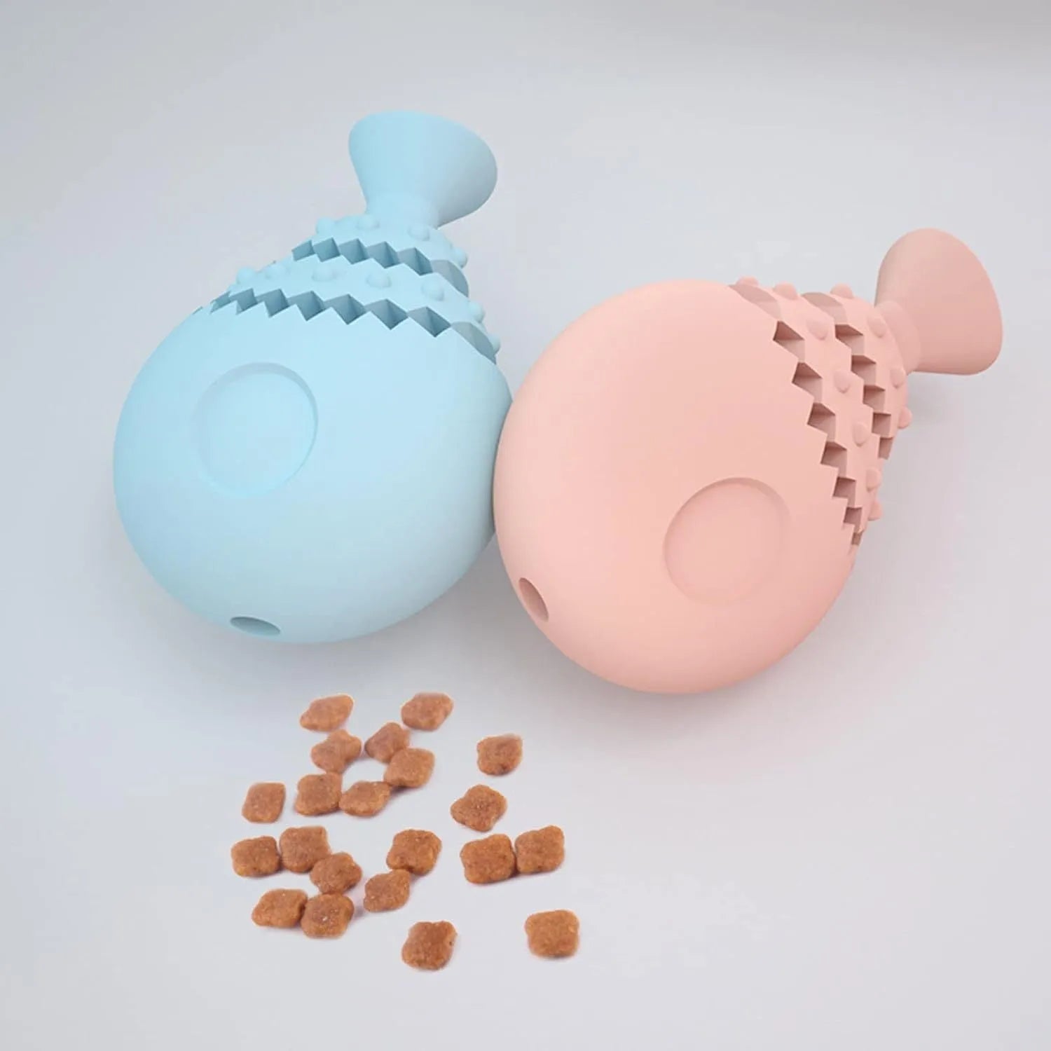 Blue fish bone shaped dog chew toy for teeth cleaning with a treat hole, shown next to a green and pink version.