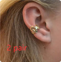 Gold-coloured women's earrings with conch and starfish beach-themed decorative elements