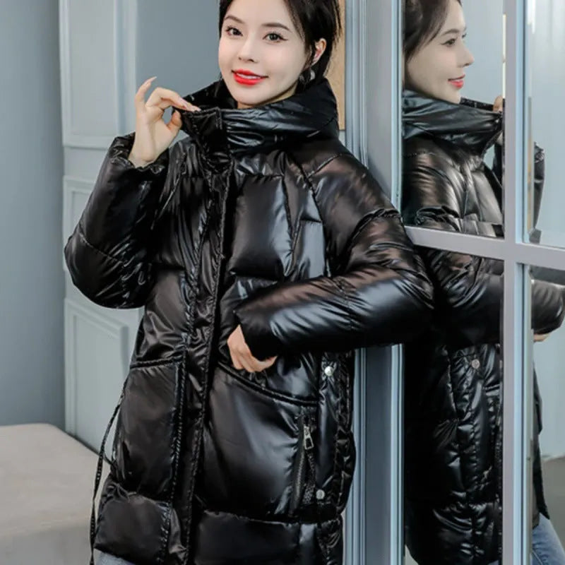 Women's loose fit thick hooded down cotton jacket in black, shown with long sleeves and a front zip.