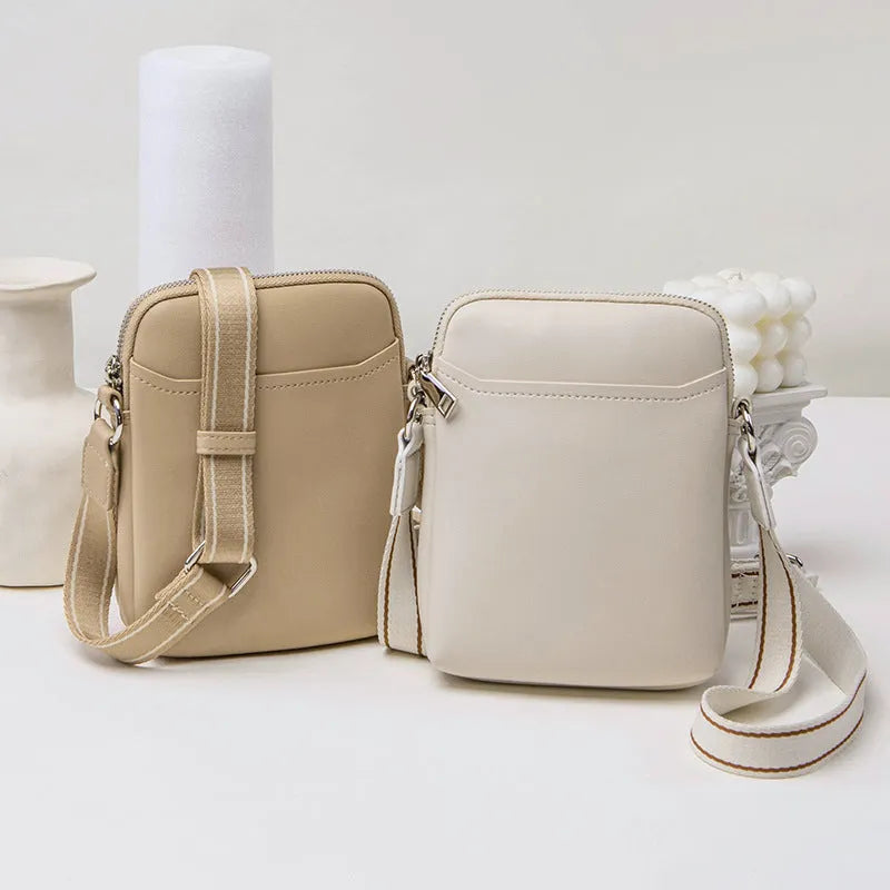 Small solid colour mobile phone crossbody bag in PU leather measuring 14.5cm wide