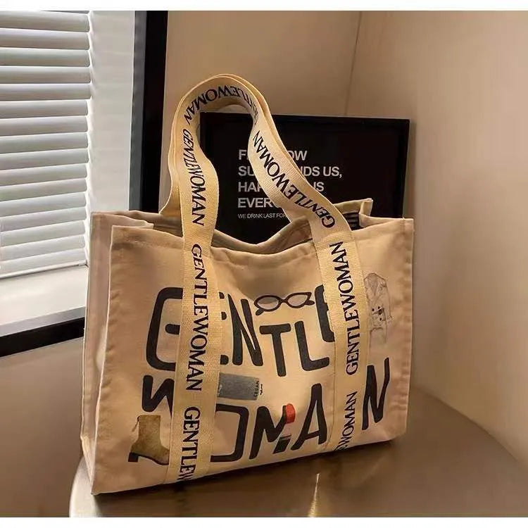 Women's large canvas tote bag with printed design options for travel and shopping.
