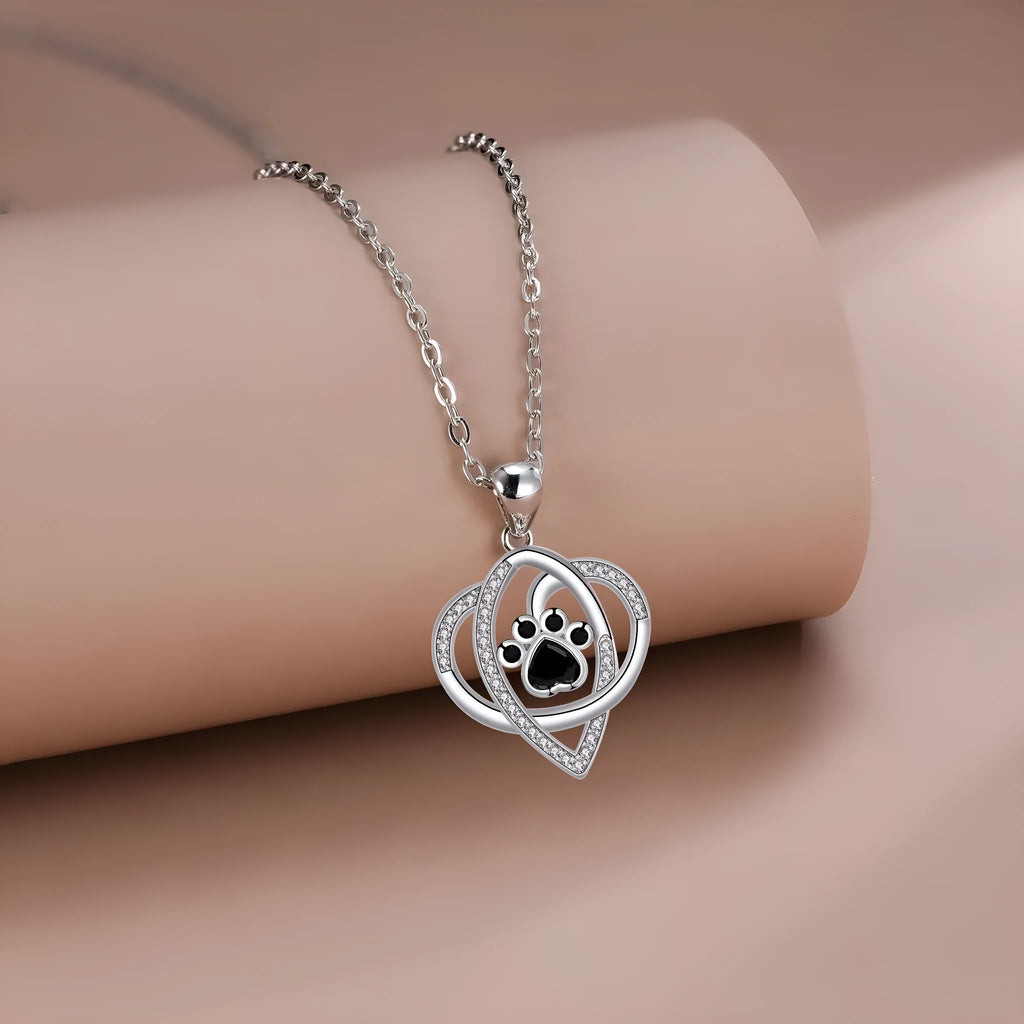 Silver tone dog and cat paw print necklace with cross chain design