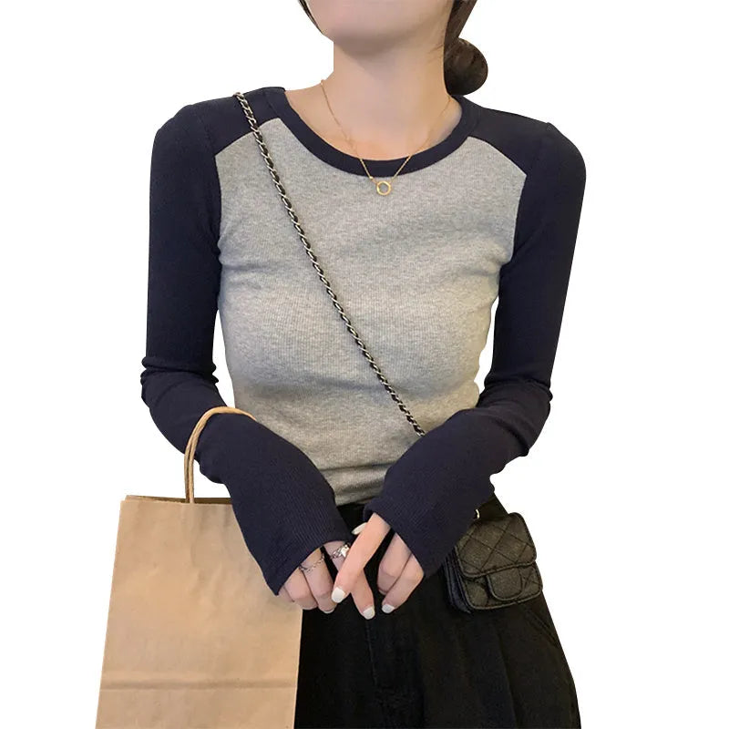 Women's dark blue viscose top with princess sleeves and embroidery detail on a hanger.