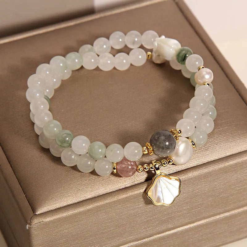 Women's crystal bracelet with an apricot leaf pendant and gold-plated gemstone accents in a green Tianshan jade colour.
