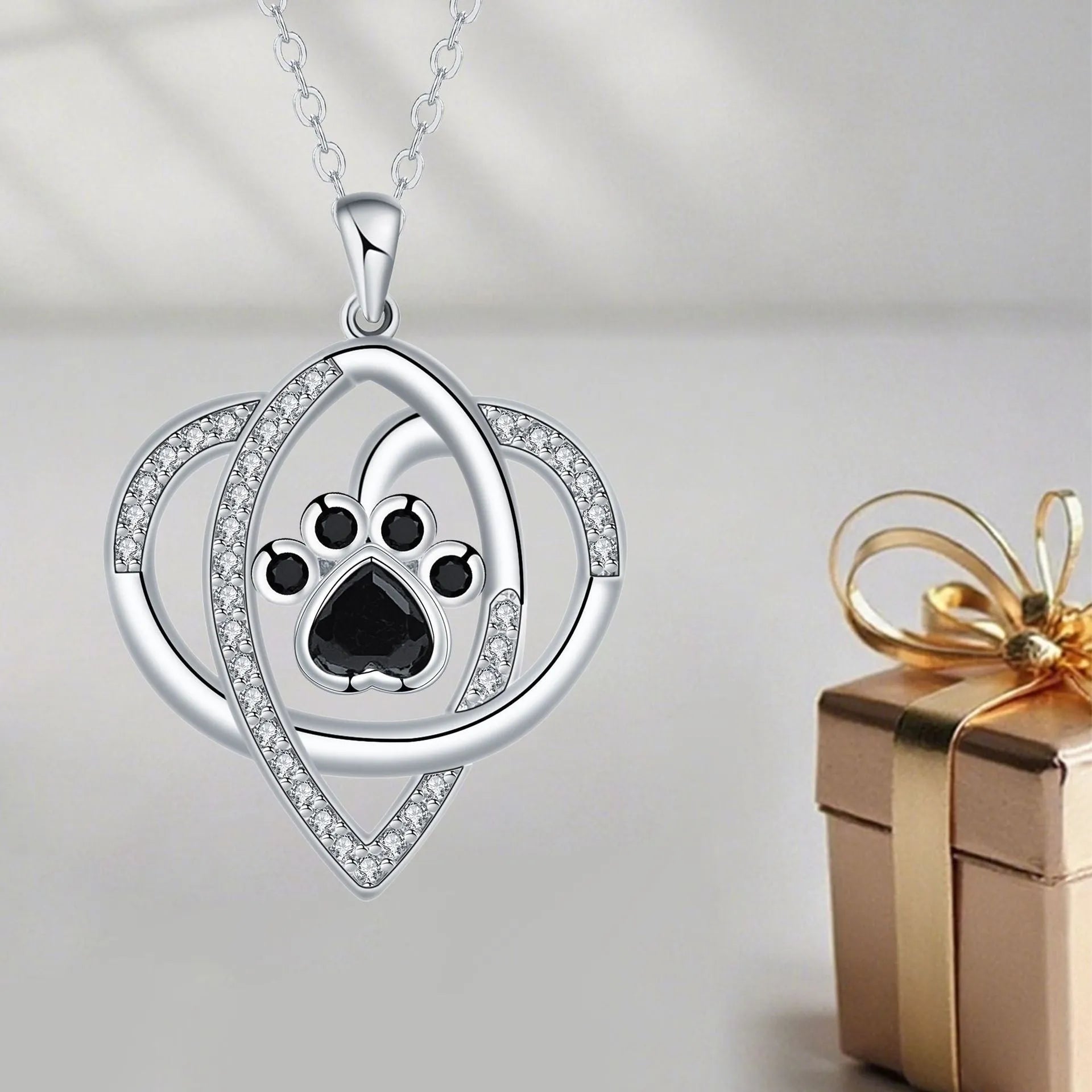 Silver tone dog and cat paw print necklace with cross chain design