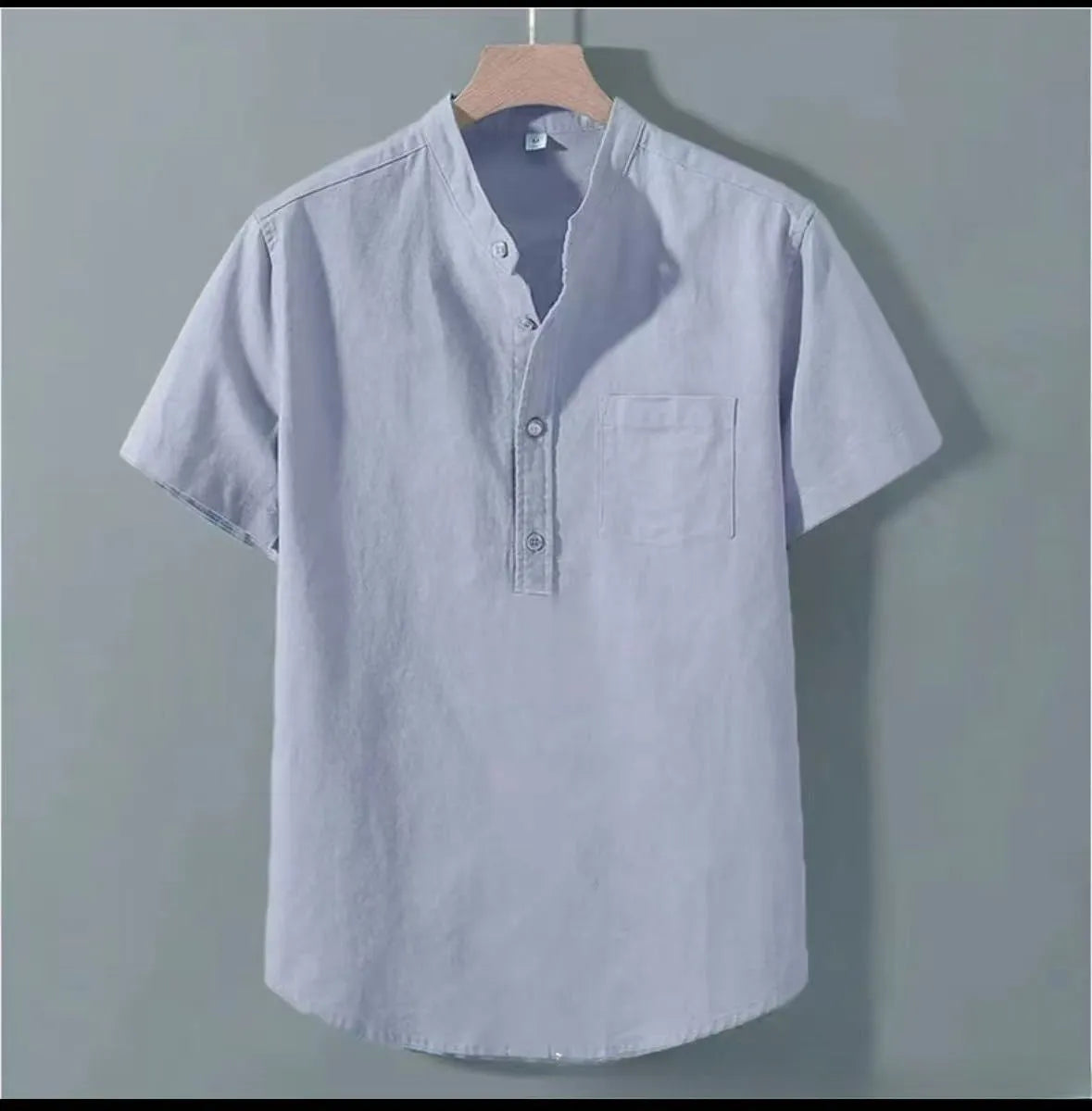 Men's beige loose-fit linen short sleeve shirt with a stand collar on a hanger.