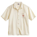 Light apricot men's Cuban collar shirt with a bamboo leaf and flower print