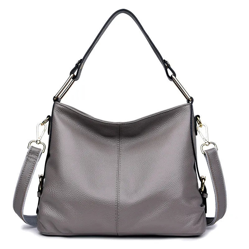 Genuine leather vertical square crossbody bag showing internal zipper compartments and external sandwich pocket