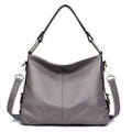 Genuine leather vertical square crossbody bag showing internal zipper compartments and external sandwich pocket