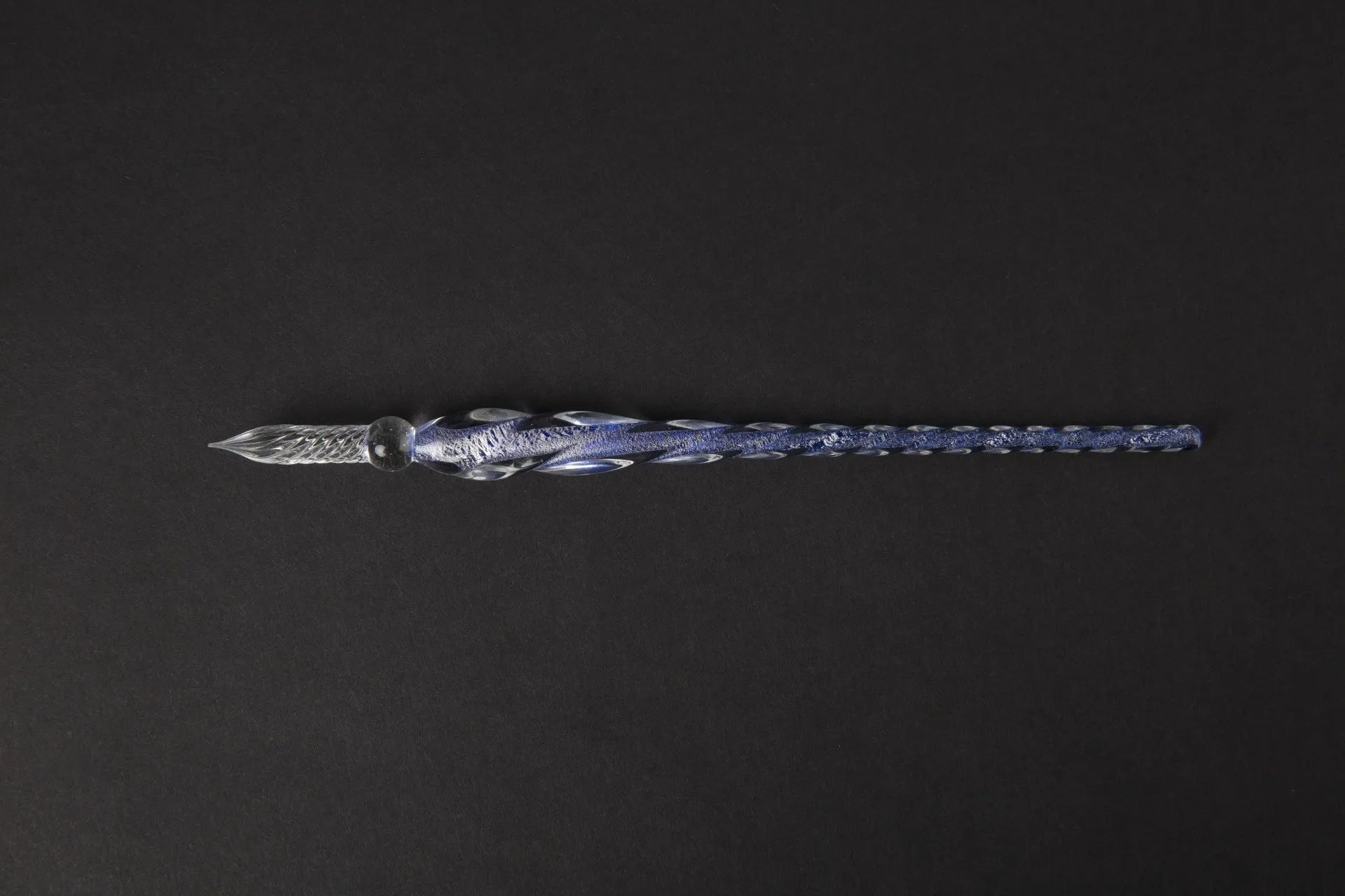 Transparent glass signature pen with coloured ink visible inside, abstract modelling, gift box packaging