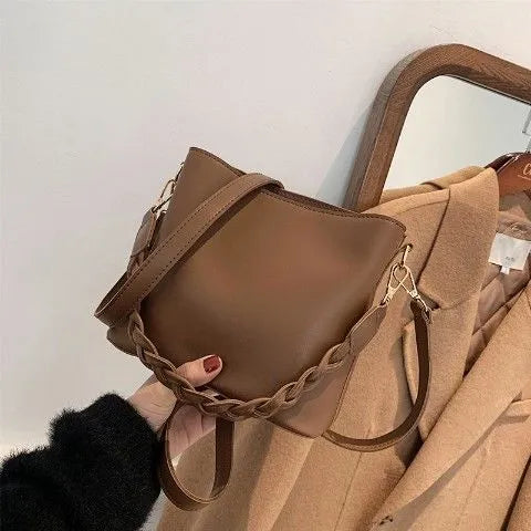 Retro woven PU leather crossbody bucket bag in khaki colour showing underarm design and textured surface