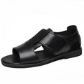 Men's black leather casual sandals with open toe and rubber sole on a plain background.
