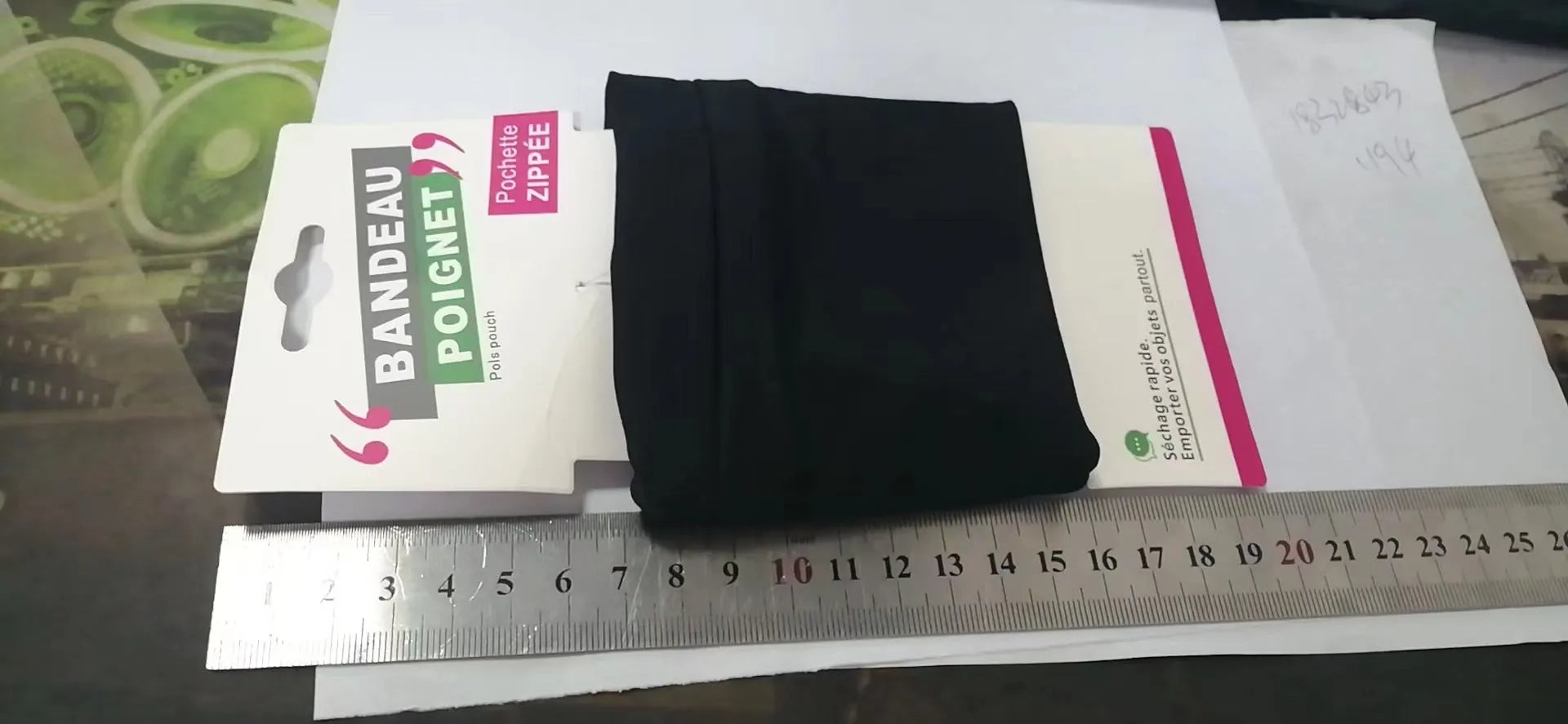 Wrist bag armband sleeve for mobile phone, shown in packaging, dimensions 10 by 10.5 cm.