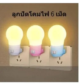 Plug-in bedside baby night light in white, blue, or pink shell with round design on a table