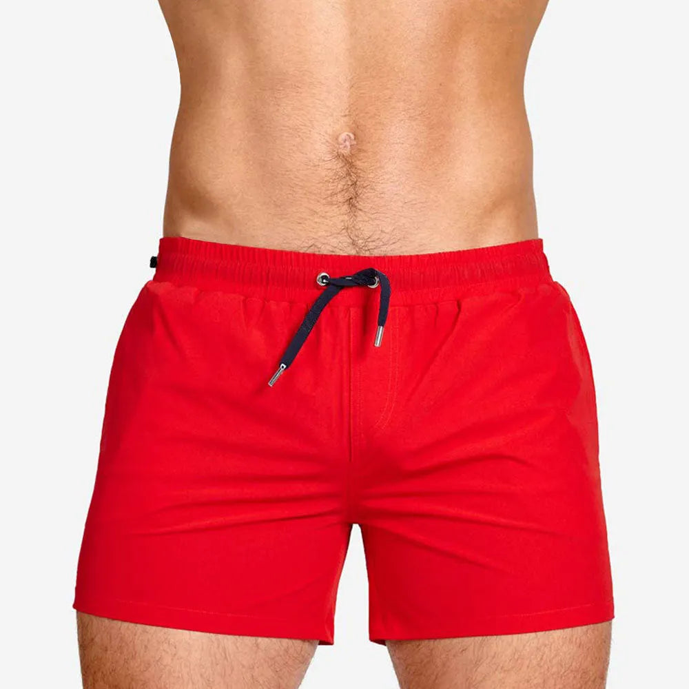 Mesh lining polyester sports shorts in solid colours for swimming and fitness.