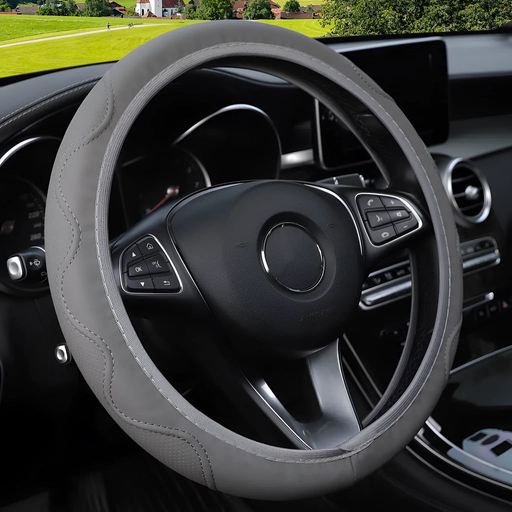 Black elastic steering wheel cover with a corrugated texture, stretched to show its fit.