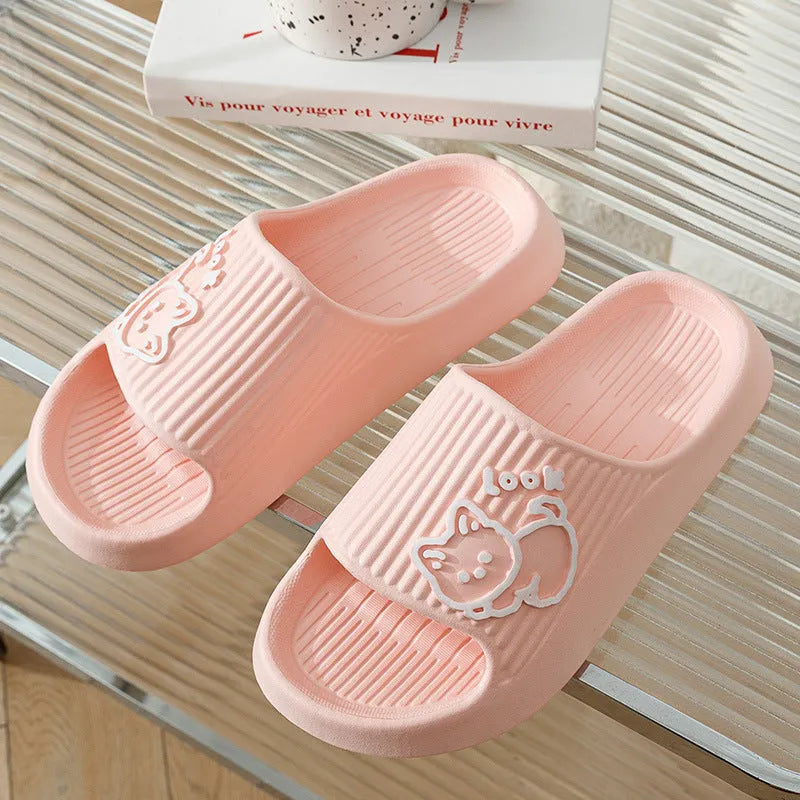 Green EVA platform flip flop slippers with a raised cat design on the upper.